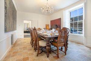 a dining room with a table and chairs at Silver Street Townhouse - Grampian Lettings in Aberdeen