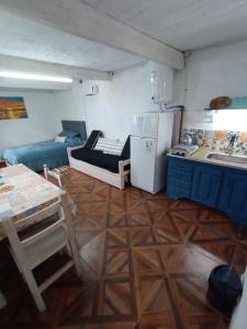 a small room with a kitchen and a refrigerator at Monoambiente Loft La Tranquilidad in Mar del Tuyú