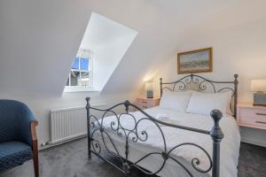 a bedroom with a bed and a chair and a window at Silver Street Townhouse - Grampian Lettings in Aberdeen +36 photos