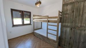 a bedroom with a bunk bed and a window at Lavanda Apartamenty in Chłopy