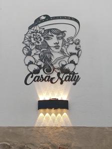 a sign for a casa salsa ally on a wall at Casa Naty in Mexico City