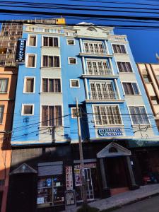 a blue and white building on a city street at Hotel Benelux in La Paz +7 photos