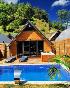 a house with a swimming pool in front of a house at Sapanca Ravine Bungalow in Sapanca
