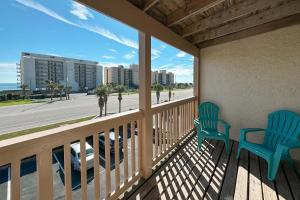 two chairs on a balcony with a view of the beach at Lei Lani Minit Tower Unit 219 in Orange Beach
