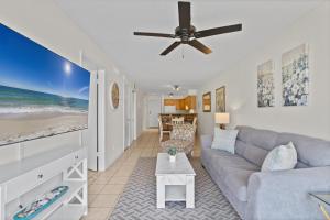a living room with a couch and a ceiling fan at Lei Lani Minit Tower Unit 219 in Orange Beach +31 photos