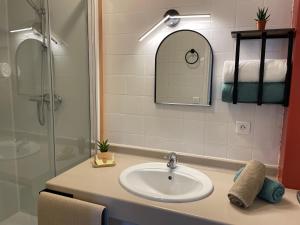 a bathroom with a sink and a shower at Le Matagot Auberge-Restaurant in Mazeyrat-Aurouze