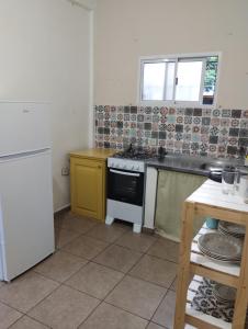 a small kitchen with a stove and a sink at Florida 68 B in Puerto Iguazú