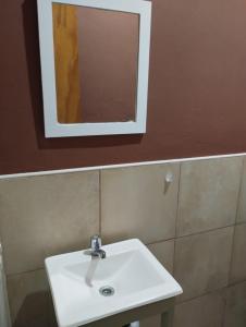 a bathroom with a white sink and a mirror at Florida 68 B in Puerto Iguazú