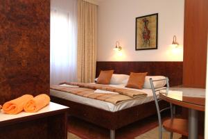 a bedroom with a bed and a table in it at Apartment Ivan in Vinišće