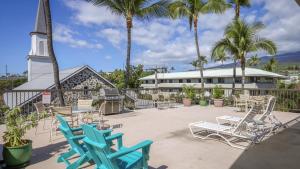 a patio with chairs and a grill and a church at Hale Lopaka at Kona Plaza in Kailua-Kona