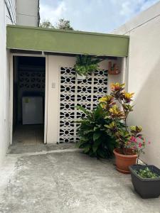 a garage with potted plants next to a building at Vargas Lodge, Costa Rica in San Vicente