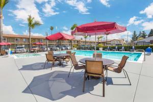 a patio with tables and chairs next to a pool at Best Western Plus Ontario Airport & Convention Center in Ontario