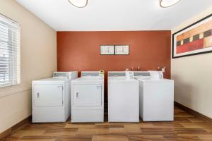three washers and dryers in a laundry room at Best Western Plus Ontario Airport & Convention Center in Ontario