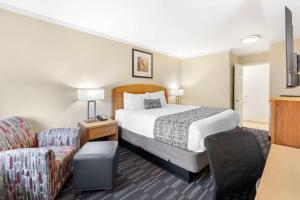 a hotel room with a bed and a chair at Best Western Plus Ontario Airport & Convention Center in Ontario