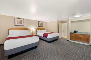 a hotel room with two beds and a bathroom at Best Western Plus Ontario Airport & Convention Center in Ontario