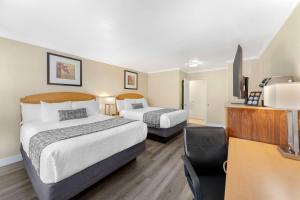 a hotel room with two beds and a desk at Best Western Plus Ontario Airport & Convention Center in Ontario