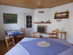 a living room with a table and a fireplace at Pension MAX in Pernink