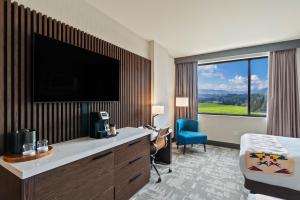 a hotel room with a flat screen tv and a bed at Spokane Tribe Resort and Casino in Airway Heights