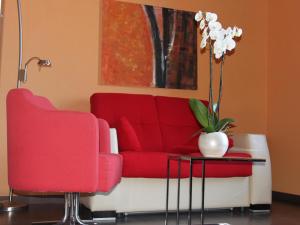 a living room with a red couch and red chairs at The Cookbook Gastro Boutique Hotel & SPA in Calpe