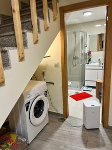 a laundry room with a washer and dryer in a bathroom at Maison L aurore in Lobios