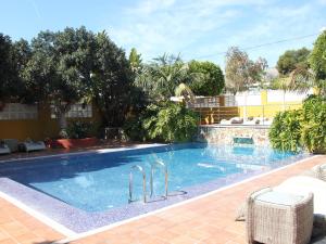 a large swimming pool in a yard with trees at The Cookbook Gastro Boutique Hotel & SPA in Calpe