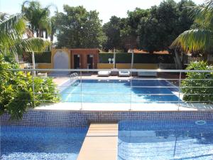 a swimming pool with two lounges and a resort at The Cookbook Gastro Boutique Hotel & SPA in Calpe