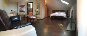 a living room with a couch and a bed in a room at The Cookbook Gastro Boutique Hotel & SPA in Calpe