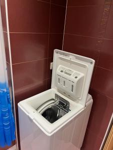 a washing machine in a toilet in a bathroom at KRL&Lu Rentals in Panevėžys +2 photos