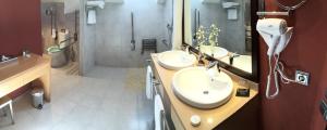 a bathroom with two sinks and a shower at The Cookbook Gastro Boutique Hotel & SPA in Calpe