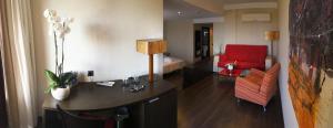 a room with a desk and a red couch at The Cookbook Gastro Boutique Hotel & SPA in Calpe