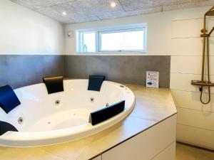 a bath tub in a bathroom with two chairs at 5 star holiday home in Glesborg-By Traum in Glesborg +43 photos