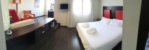a hotel room with a bed with two towels on it at The Cookbook Gastro Boutique Hotel & SPA in Calpe