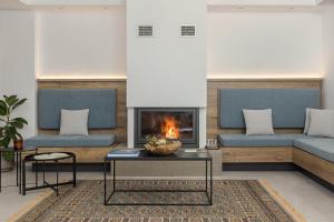 a living room with two couches and a fireplace at Areti Guesthouse in Víssani
