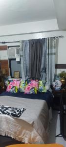 a bedroom with a bed with curtains on it at Florida sun condo in Manggahan