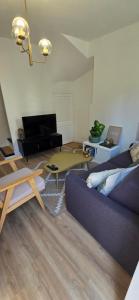 a living room with a couch and a table at L'alcôve enchantée in Rouen