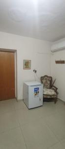 a room with a chair and a white refrigerator at Don Rufino in Cruz del Eje