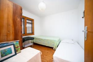 a bedroom with two beds and a table with a picture at Secluded fisherman's cottage Zman, Dugi otok - 19000 in Žman