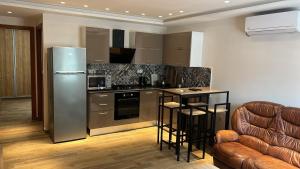 a kitchen with a stainless steel refrigerator and a counter at IQOSs in Dar Tahar Zaouch