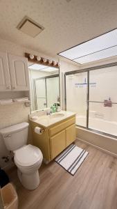 a bathroom with a toilet and a sink and a window at Perfect Coachella Getaway! in Indio
