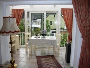 a dining room with a white table and a window at Haus Mooren, Hotel Garni in Düsseldorf
