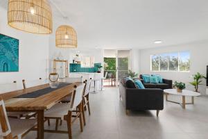 a kitchen and living room with a table and chairs at 6 Parkshores Sunshine Location Location Location 100m to beach access in Sunshine Beach