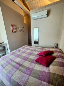 a bedroom with a large bed with red pillows on it at Luna City in Ravenna