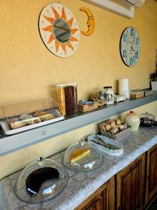 a kitchen counter with a clock on the wall at Luna City in Ravenna