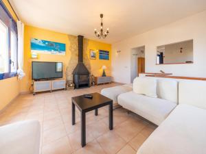 a living room with a couch and a tv at Villa in L'Escala near Platja de Riells Beach in L'Escala