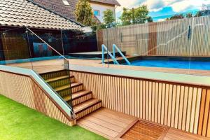 a swimming pool with a staircase next to a house at Studio in Mi dzywodzie near Baltic Beaches in Międzywodzie +11 photos