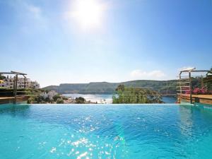 a large swimming pool with a view of a river at Luxury villa with amazing sea view in L'Escala