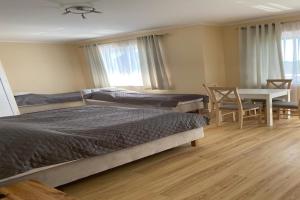 a bedroom with two beds and a table and a desk at Studio in Mi dzywodzie near Baltic Beach in Międzywodzie