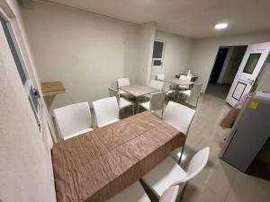 a dining room with a table and white chairs at Hotel Arbis in Puebla +50 photos