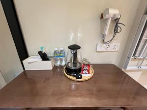 a table with a coffee maker and bottles of water at 7 minutes driving to TC Beach 123 Guest House in Kuantan