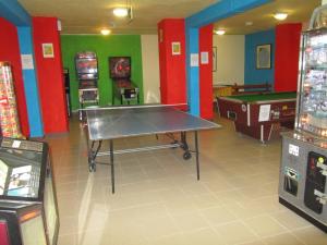 a room with a ping pong table and some games at Topaz Hotel in St Paul's Bay